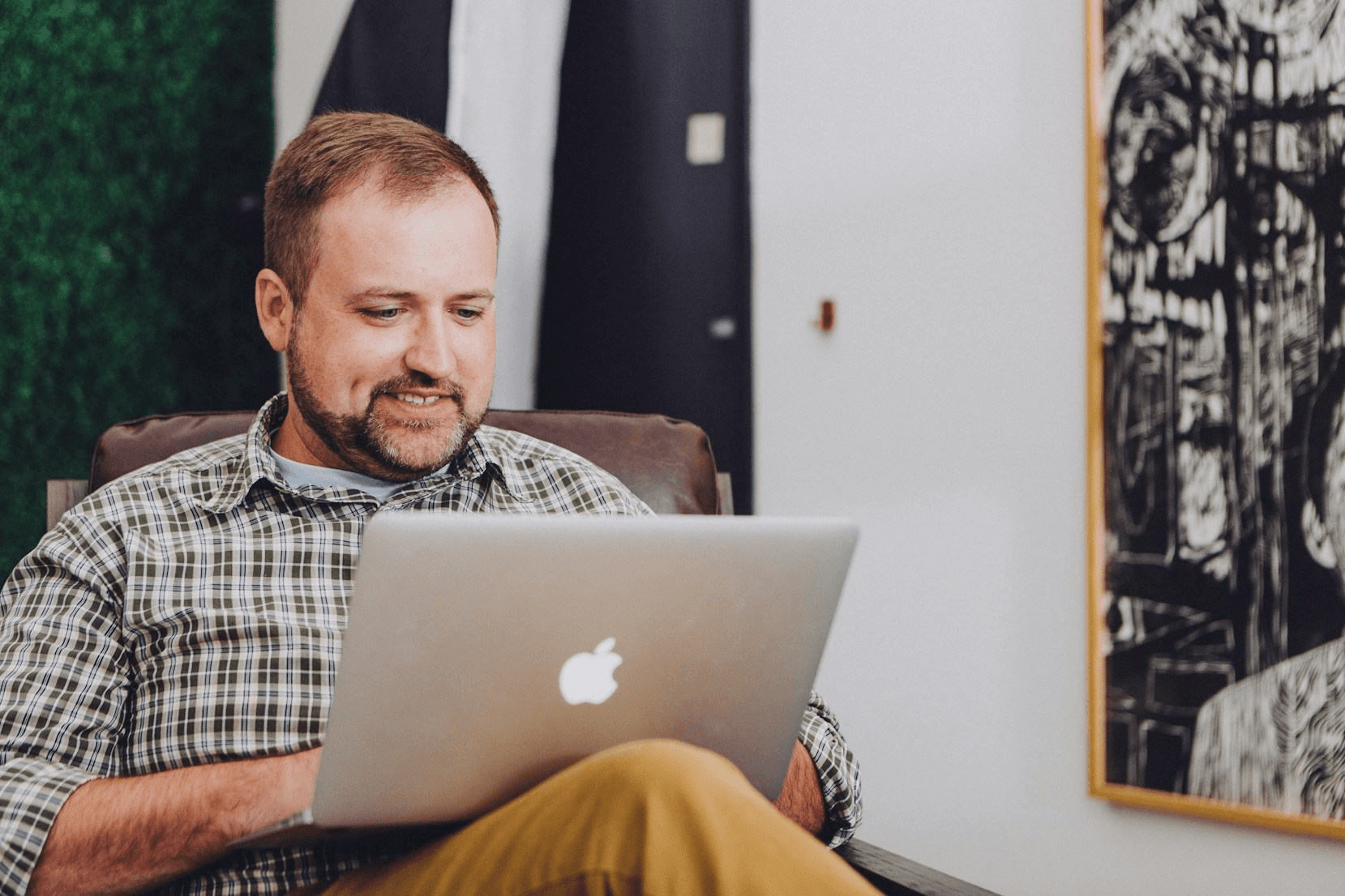 Professional analyzing property intelligence report on laptop